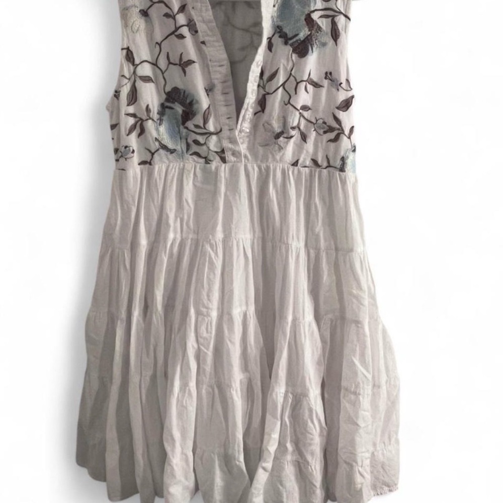 White cottagecore mini dress with embroidered flowers and branches detailing